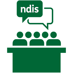 A group of people at a table talking about the NDIS